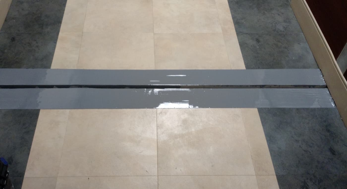 Roof expansion joint cleaned and sealed to stop water entry.