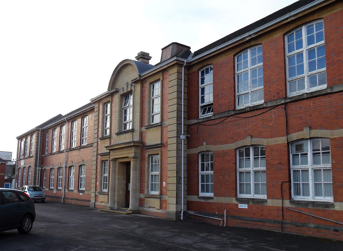 School building suffering from water ingress and dirt on the brickwork