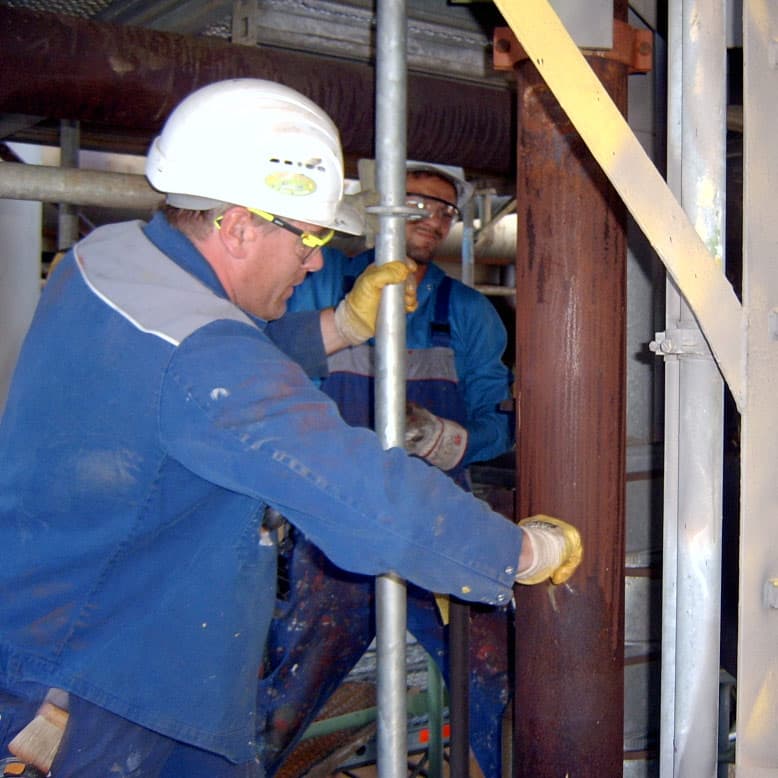 Surface preparation of corroded pipework within a refinery
