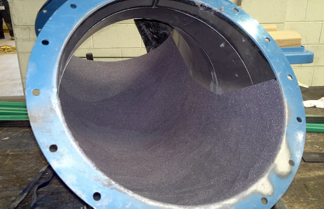 Chute interior lined with a Belzona ceramic-carbide abrasion-resistant system