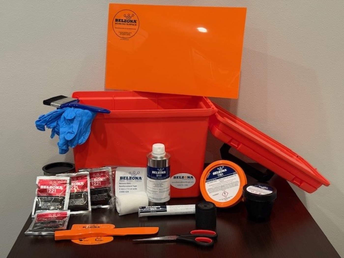Belzona Marine Repair Kit (MRK, ABS Approved) — orange waterproof toolbox with Belzona 1161, reinforcement tape, gloves and application tools laid out